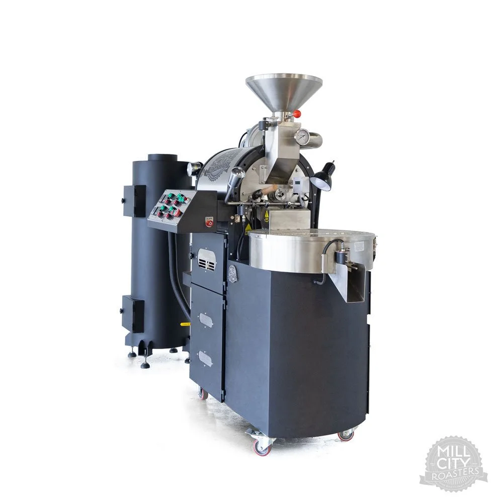 Industrial coffee roasting machine with a control panel, cooling tray, and funnel for beans, used in coffee production.