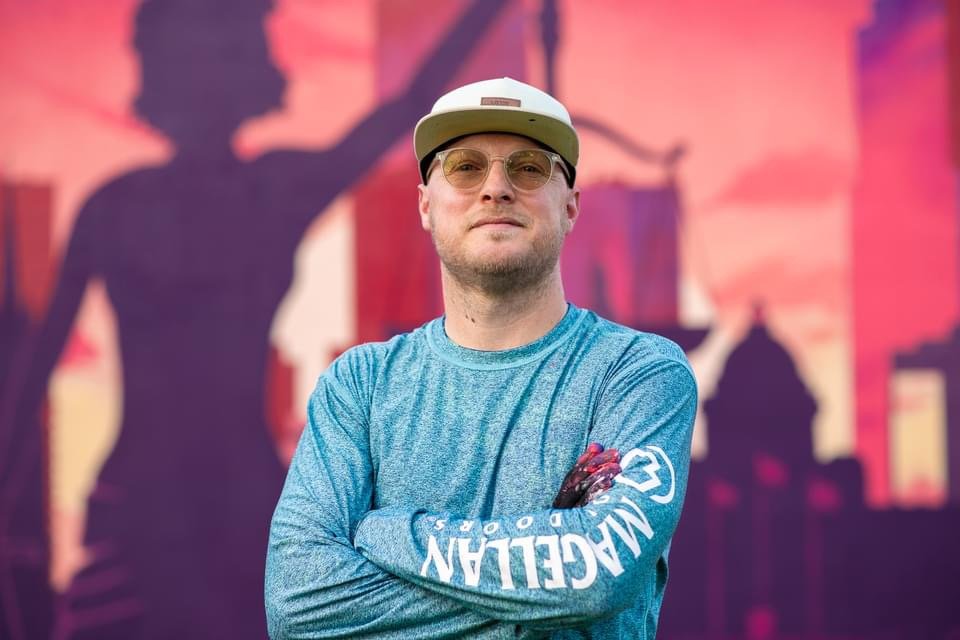 Joel Boyd in front of Lady Justice mural
