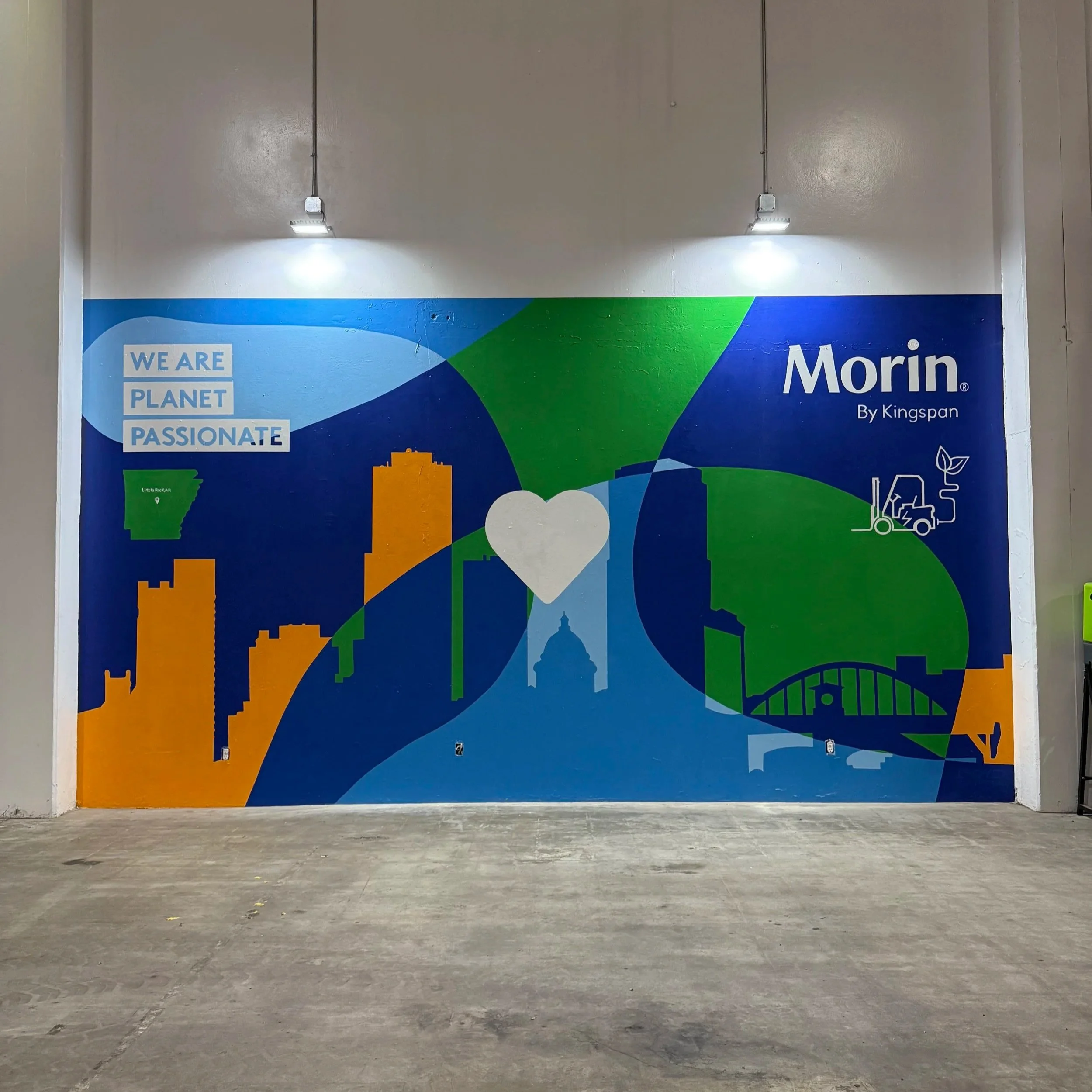 Blue, Green, Yellow Morin Corporate Kingspan  mural that reads, "We are Planet Passionate"