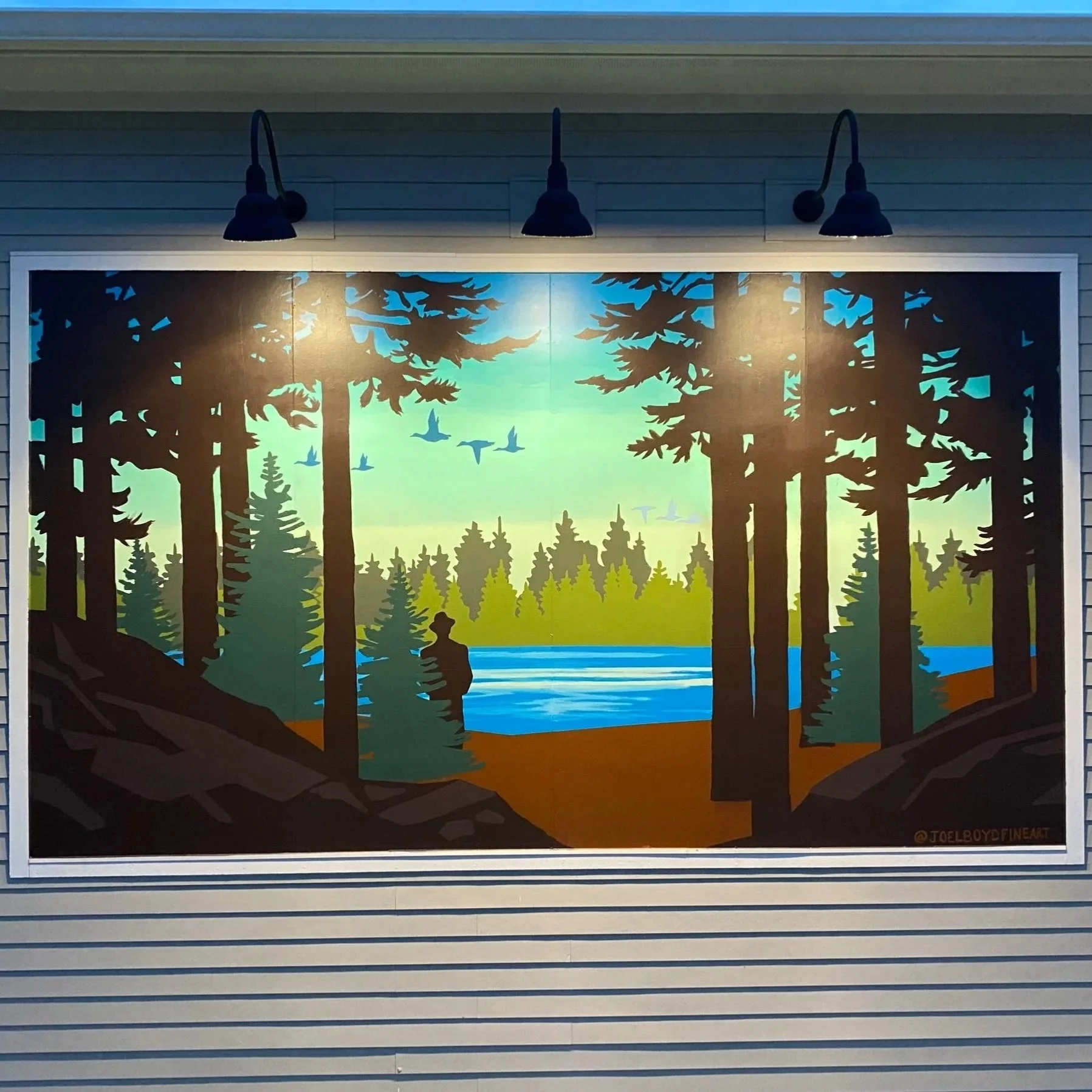 Serene mural of man standing near lake and woodsy area and ducks flying.