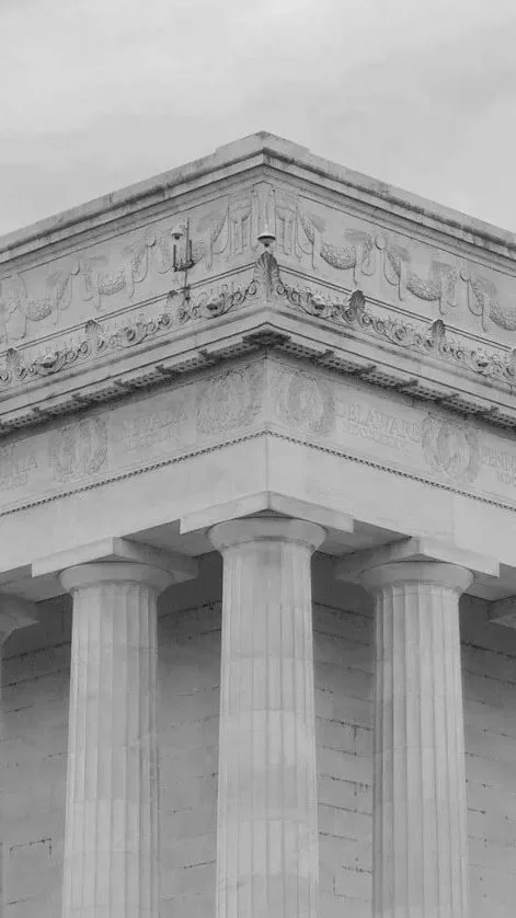 Close-up of the upper part of the Lincoln Memorial, showing its Greek Doric columns and detailed frieze.