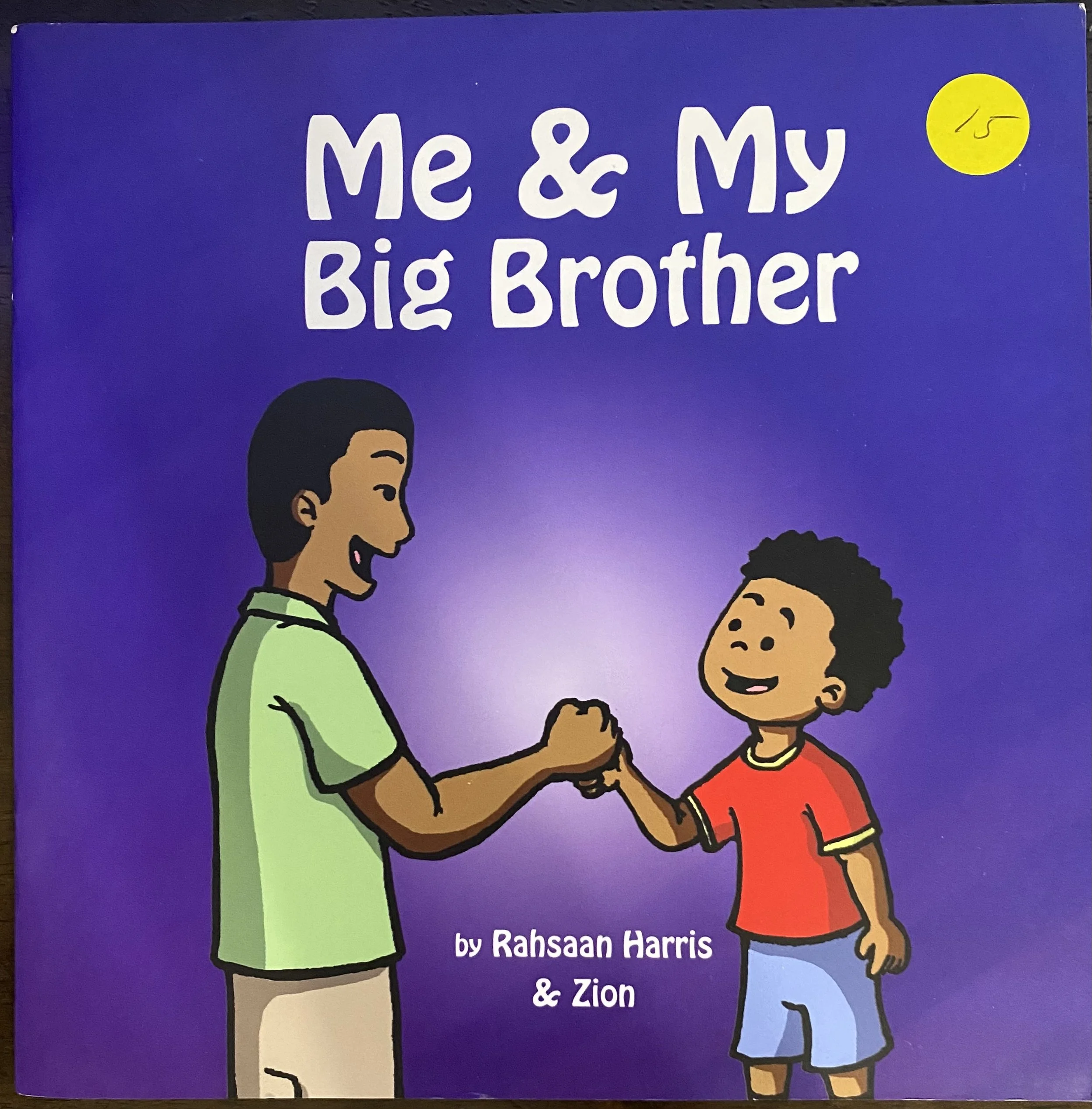 Book cover titled 'Me & My Big Brother' by Rahsaaan Harris and Zion, showing a cartoon of a young man and boy holding hands, with a purple background and a yellow circle with the price '15' in the top right corner.