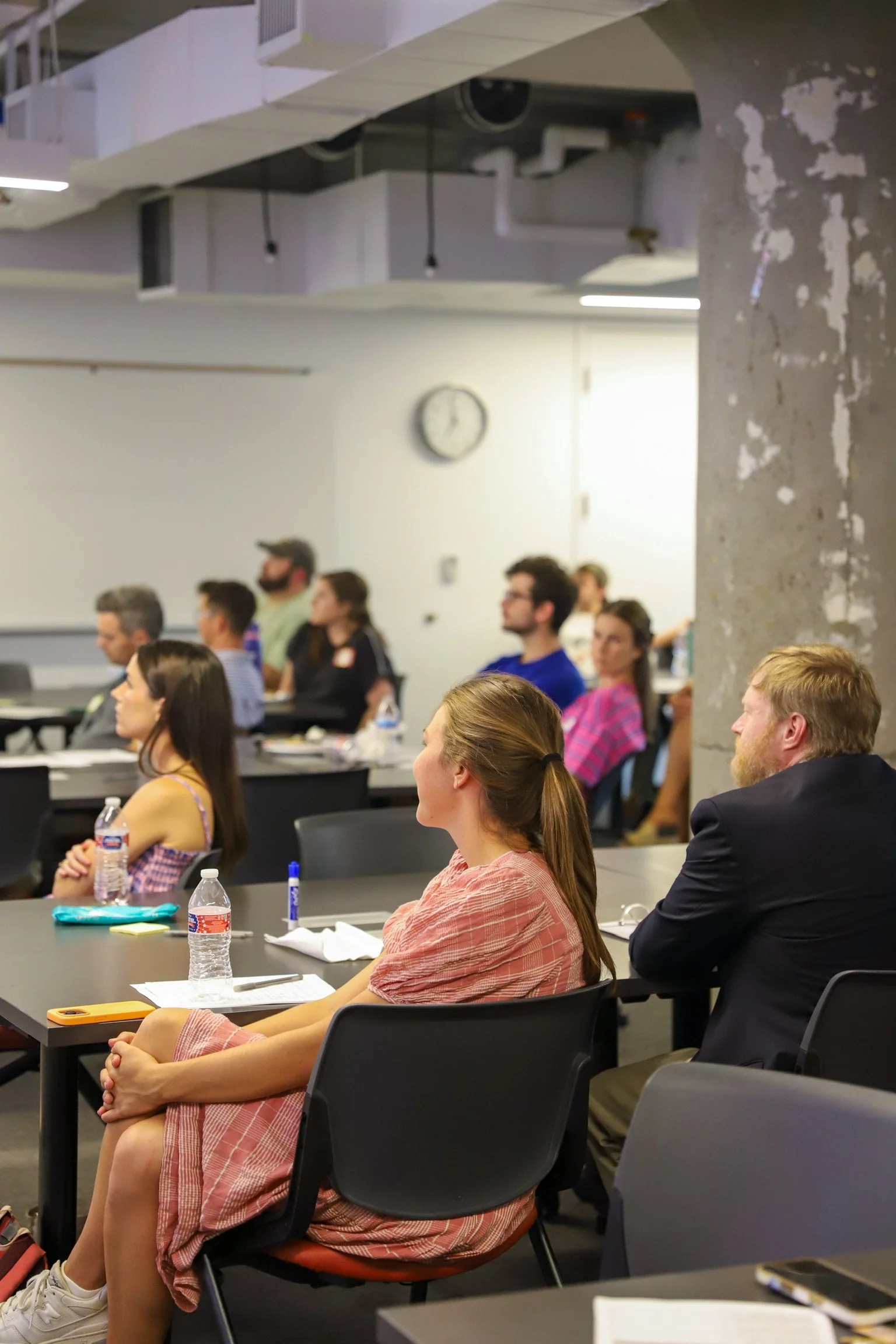 Group of people listening to presentation.