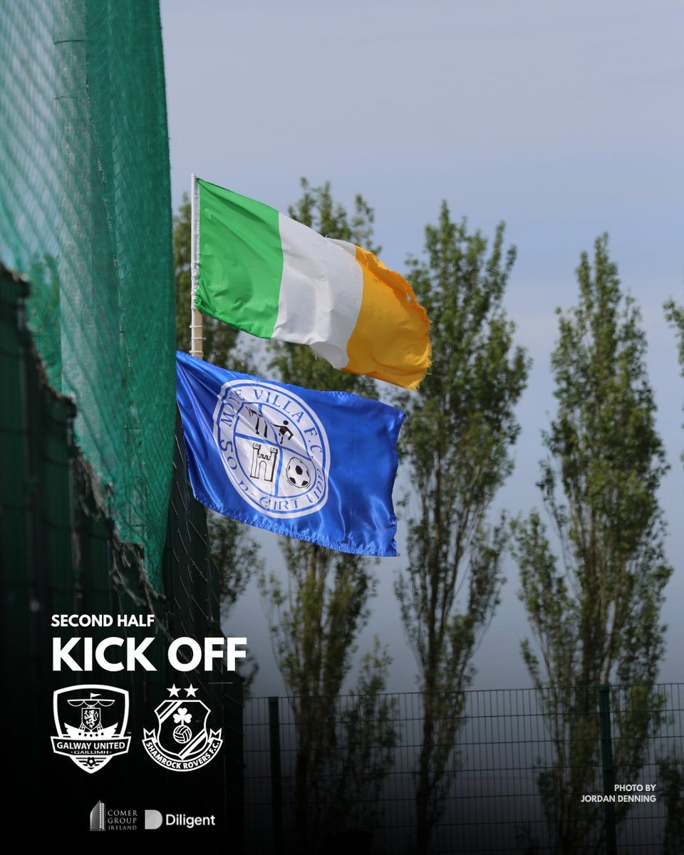 Irish flag and shamrock Rovers football club flag flying on a fence, with trees and cloudy sky in the background, promoting a second half kickoff for a soccer match between Galway United and Shamrock Rovers.