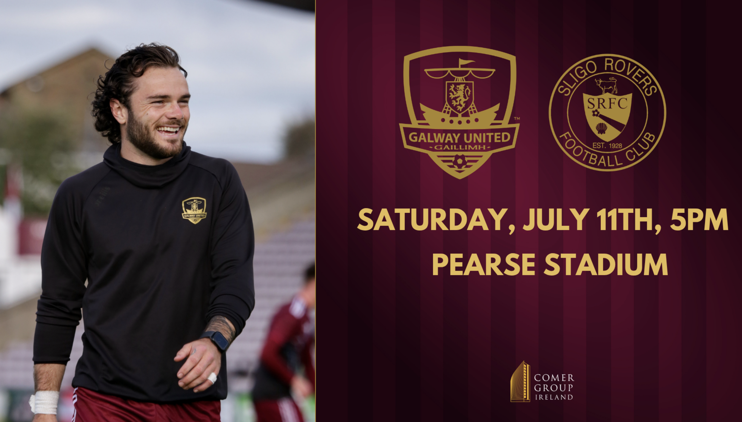 A smiling man with curly hair and a beard, wearing a black athletic shirt with Galway United logo, walking outdoors with a blurred background of a stadium and other people.