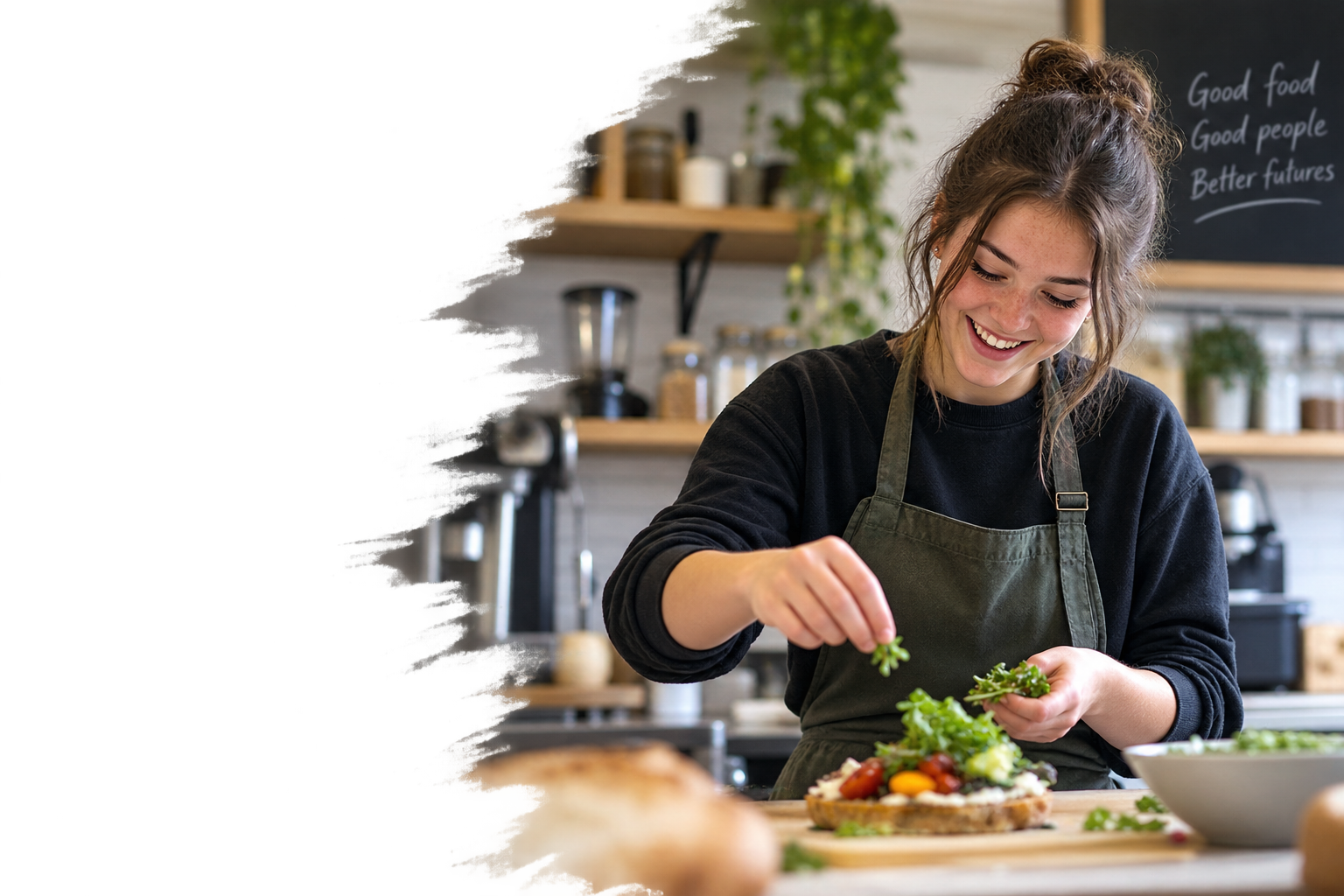 A young woman preparing a salad in a cozy kitchen, smiling while adding fresh greens to a dish.