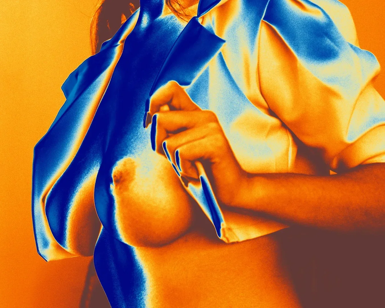 A woman lifting a shirt to reveal one breast, with a predominantly orange and blue colour filter applied to the image. Nude Art Photography by Vlad Goth.