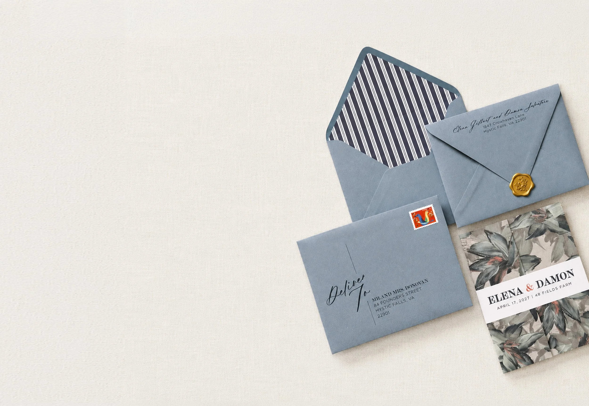 Blue-green custom wedding invitation suite with stripe envelope liners, stamp and gold wax seal by Studio Amper.