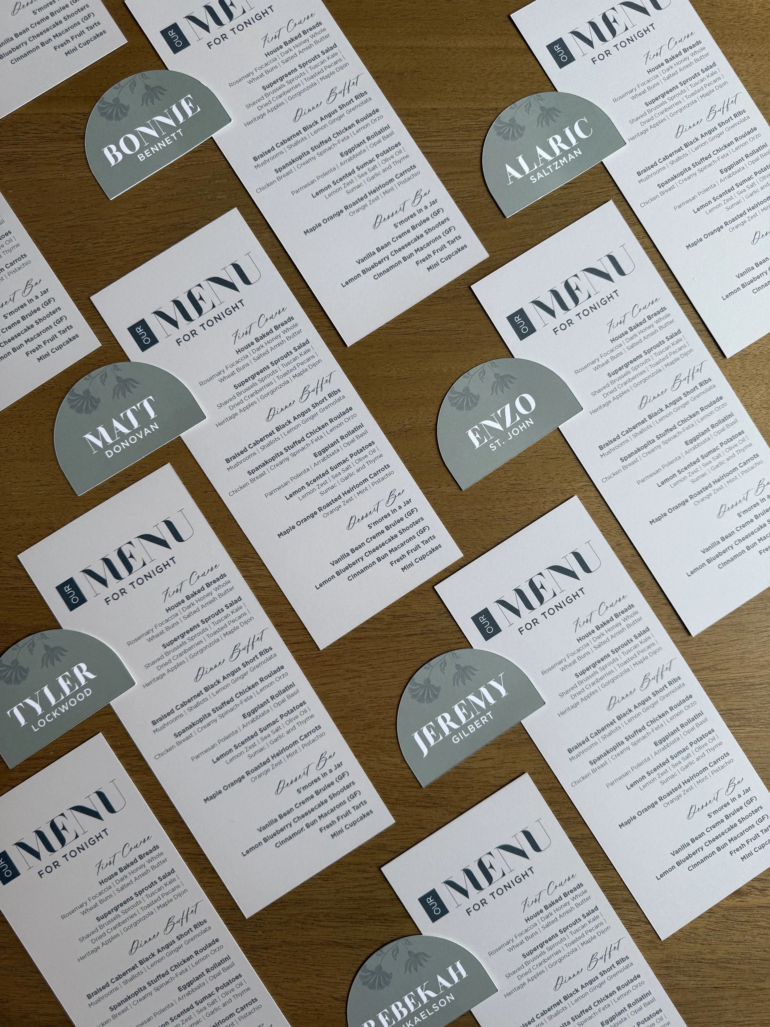 Coordinating wedding menus and place cards designed to carry the invitation style through the wedding day.