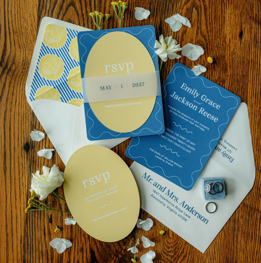 Blue and yellow custom wedding invitation suite with oval RSVP card, floral envelope liner and vellum belly band for a Willow Brook wedding in Virginia.