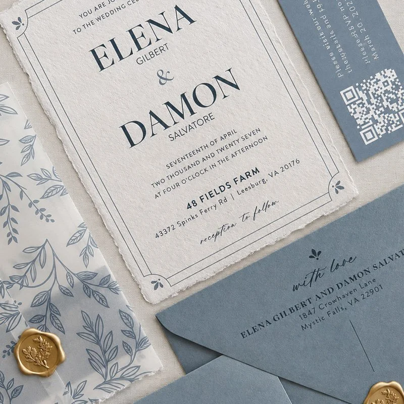 Wedding invitation card for Elena Gilbert and Damon Salvatore, with details of the ceremony and reception, along with blue envelope and decorative paper, gold wax seal, and a RSVP card with a QR code.