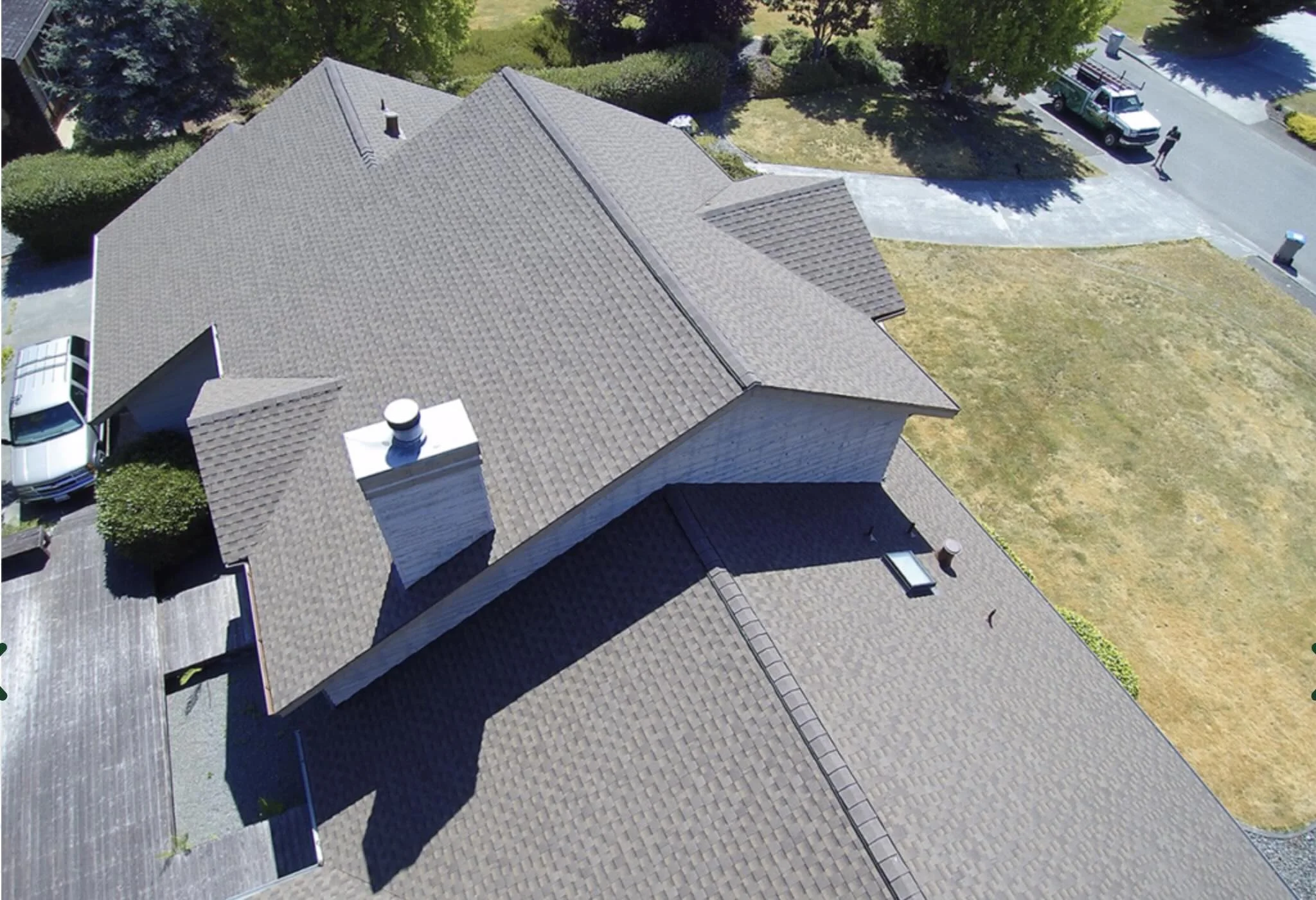 Aerial view of a completed asphalt shingle roof on an Arcata, California home
