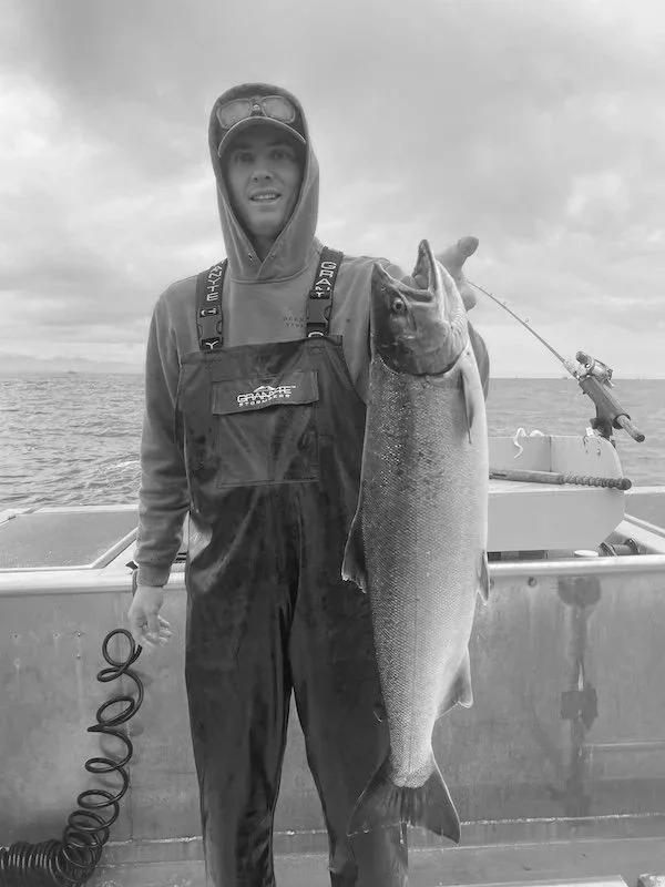 David McMurray III holding a fish on a boat