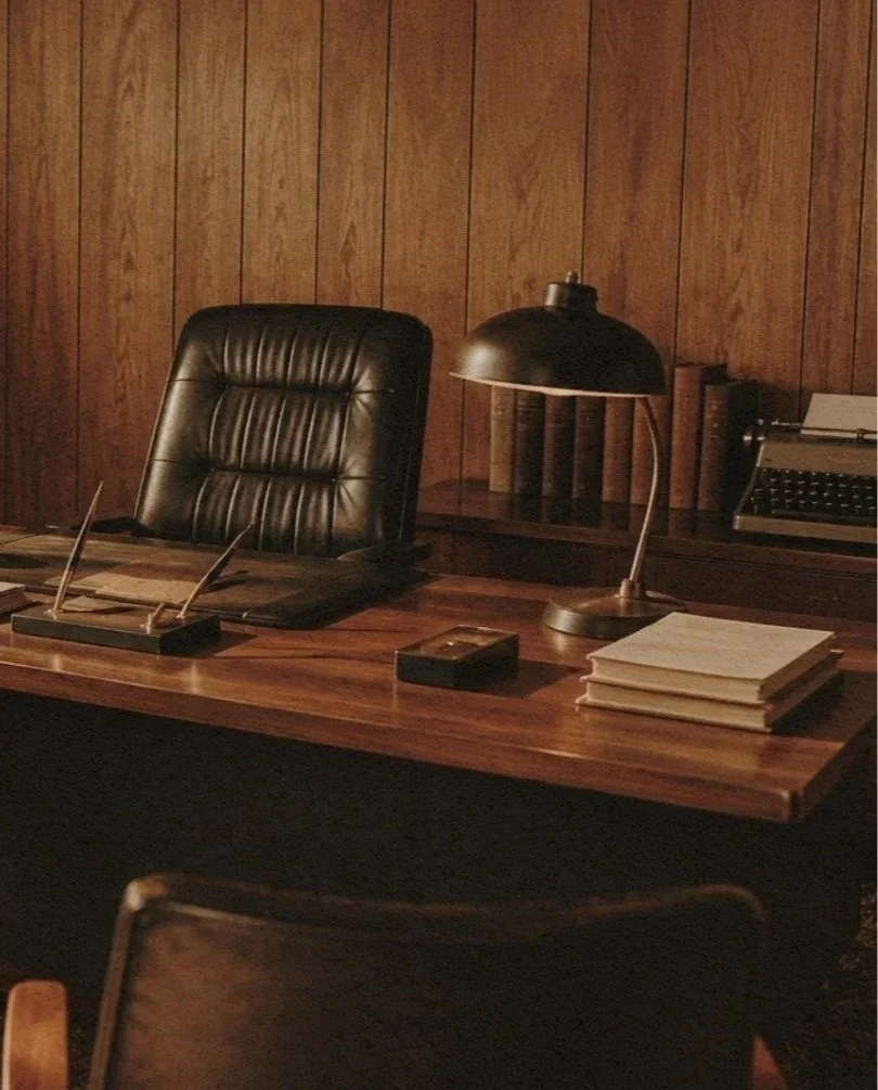 Old wood-paneled office that represents McMurray & Sons roofing company headquarters.