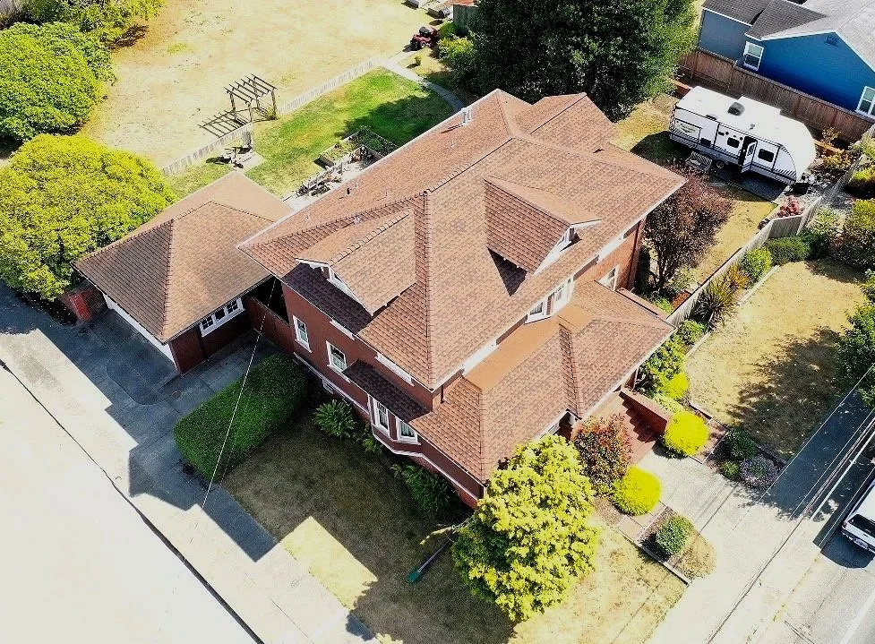 Eureka home with newly finished asphalt shingle roof by McMurray & Sons Roofing