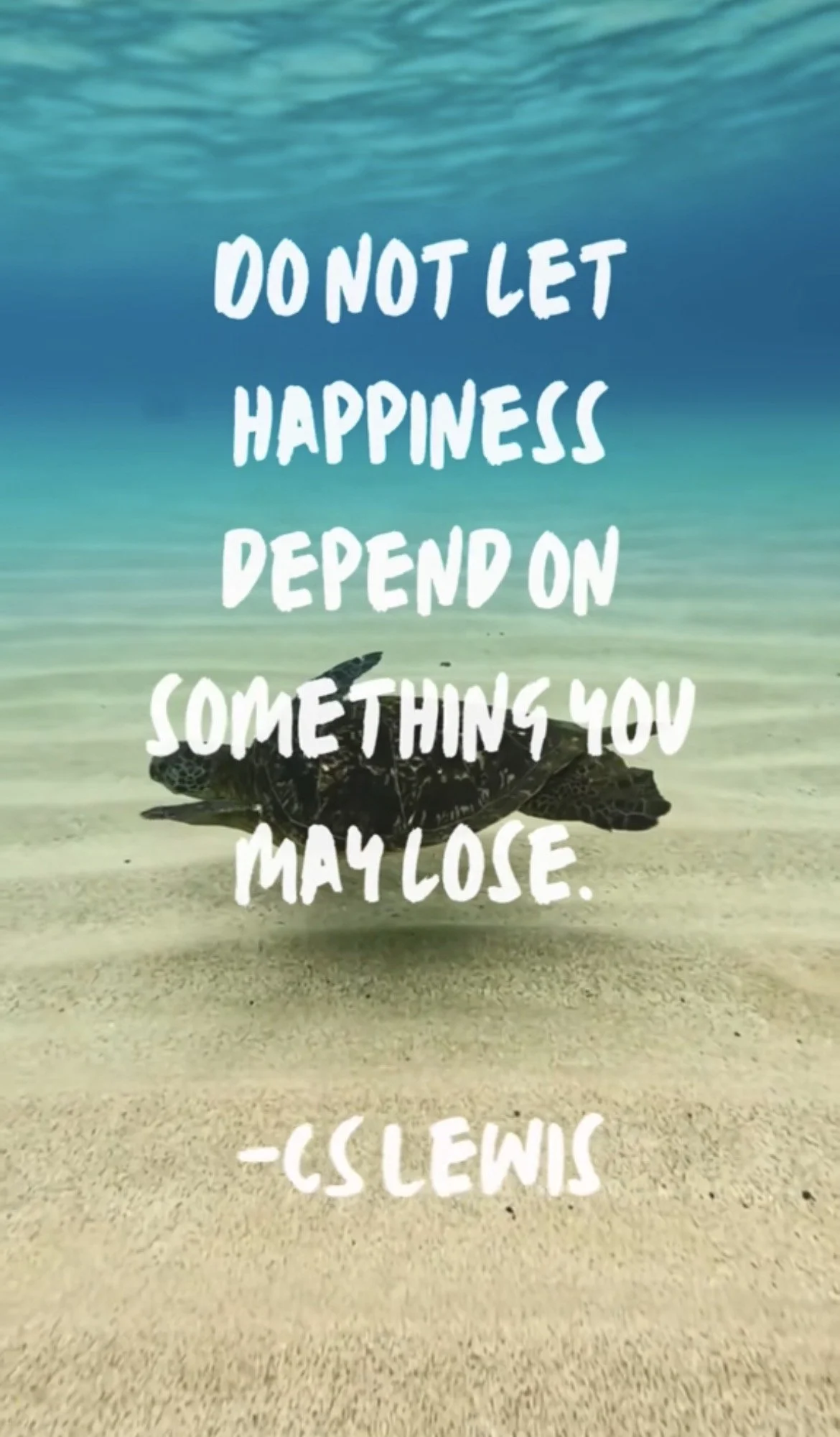 A sea turtle swimming in clear ocean water near a sandy seabed with overlaid text that reads, 'Do not let happiness depend on something you may lose,' attributed to C. Lewis.
