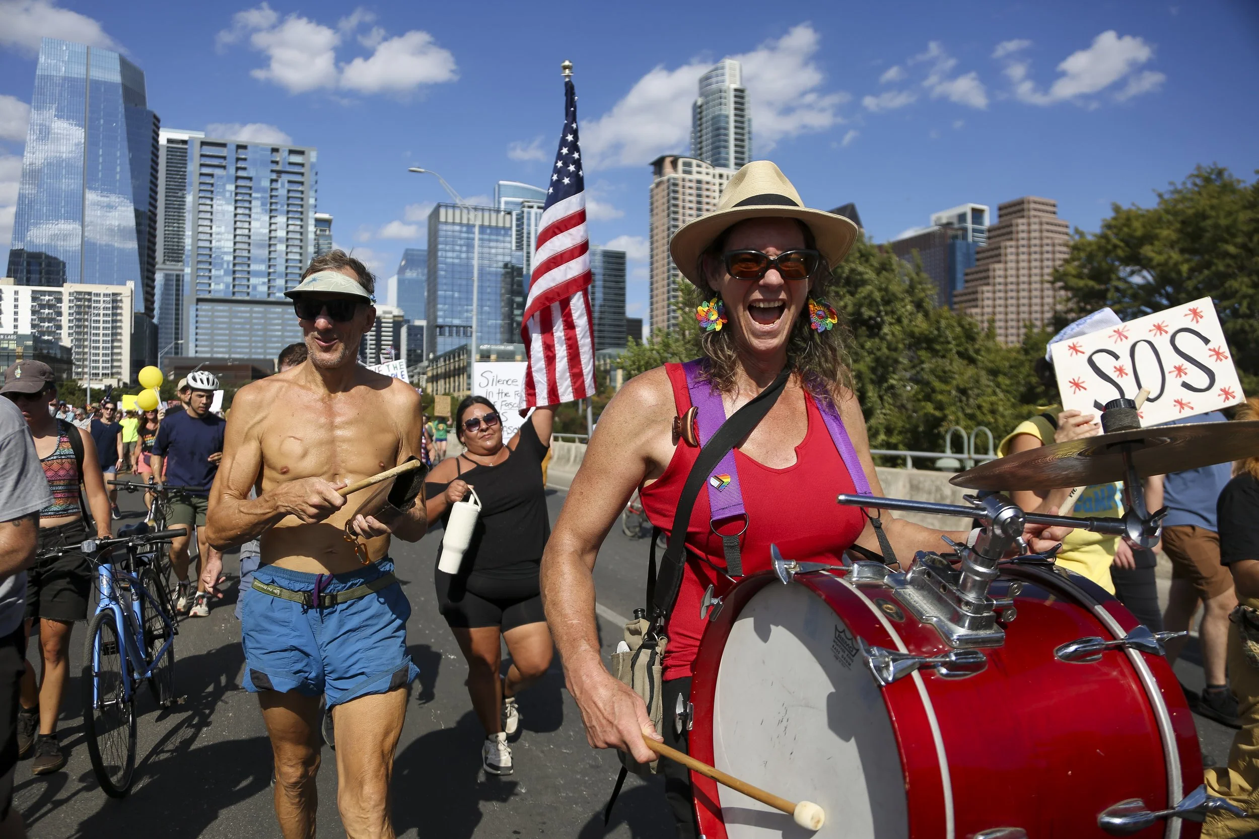 Participants of the No Kings Protest in Austin, Texas play instruments as they march down Congress Street on Oct. 18, 2025.