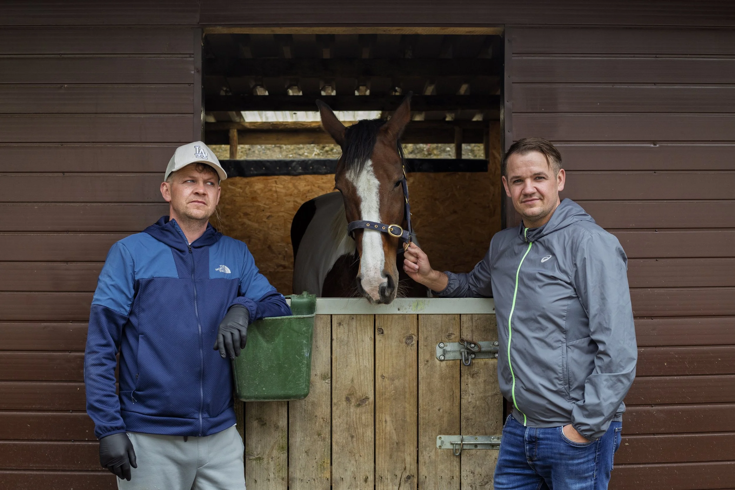 Joe and Martin Joyce pose for a portrait with their stallion in Finglas, Ireland on May 19, 2026. The Joyce brothers train and raise horses to race on the streets of Dublin. They claim that the most money they've ever raised for charity after winning