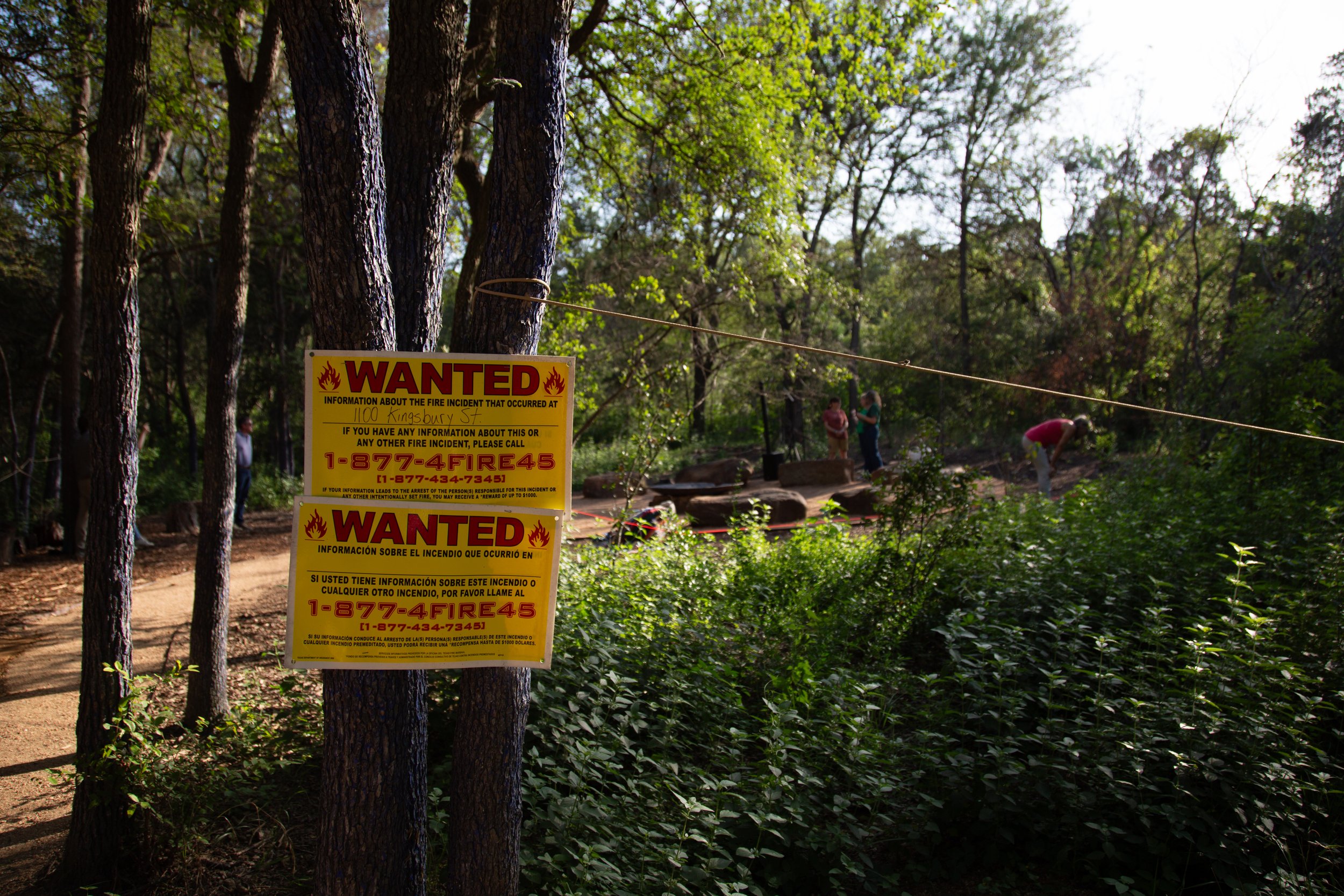 A sign requesting information to the burning of Malin the Troll in Pease Park, Austin, Texas, is posted ahead of Malin's Memorial on June 24, 2026. Hundreds gathered in Pease Park on Wednesday evening to celebrate the wooden troll sculpture that burn
