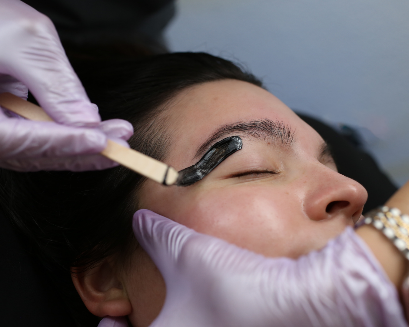 Person receiving brow waxing treatment at a spa near Henderson NV