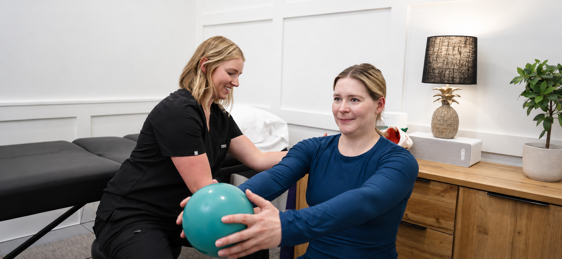 Hailey Colbert, physical therapist and owner of Phocus Physical Therapy in Wilmington, NC treating a female patient in a one-on-one setting with individualized treatment plan and goals for orthopedic conditions and pelvic floor conditions.