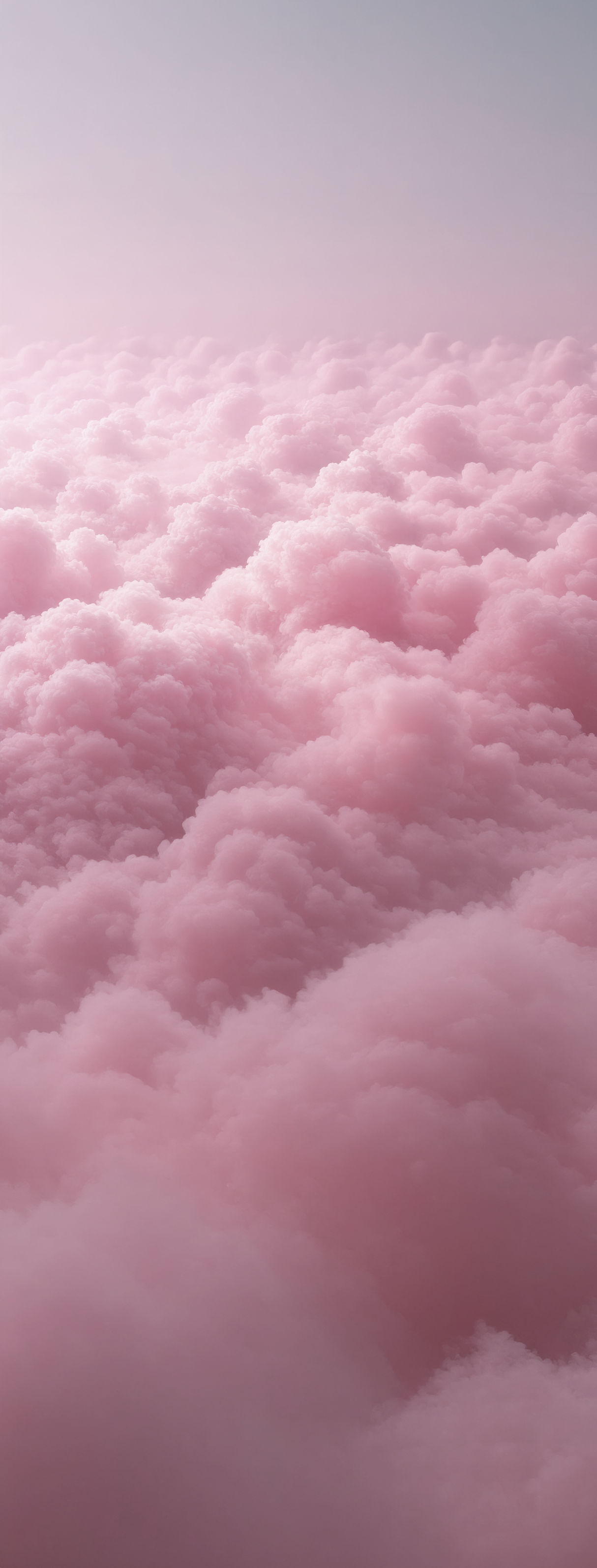 Pink fluffy clouds in the sky seen from above.