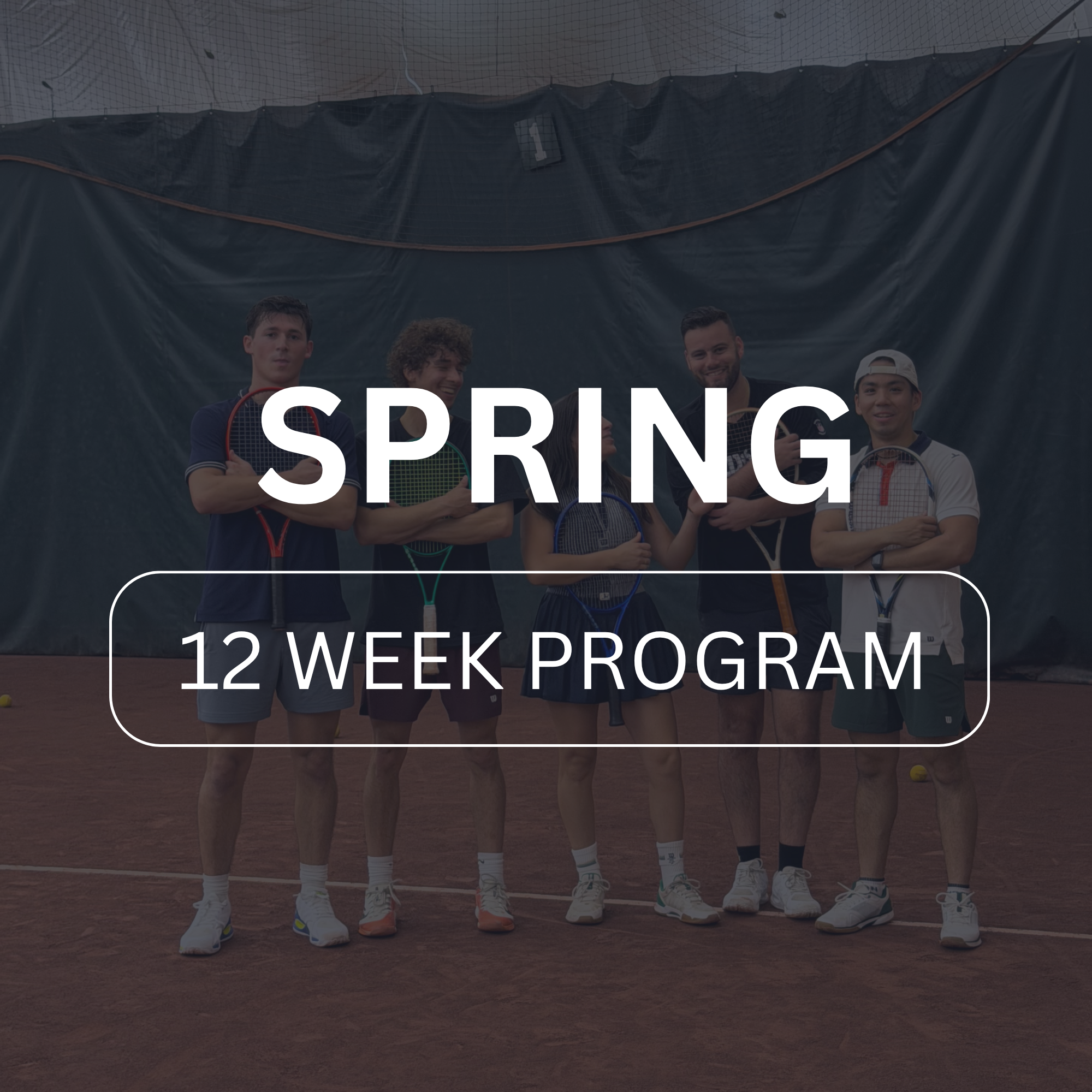 Group of five men standing on a tennis court with tennis rackets, posing for a photo during a tennis program.
