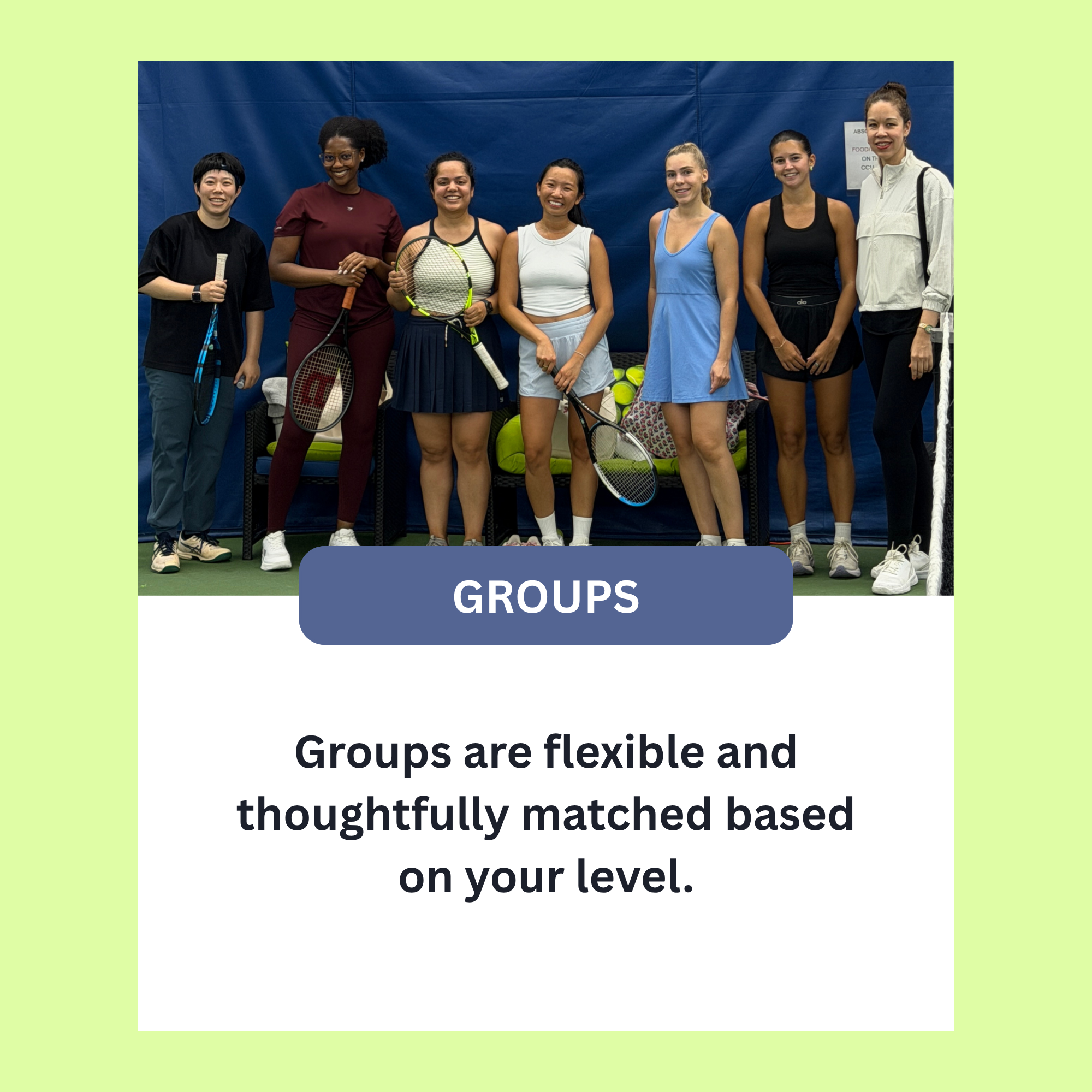 Group of diverse women in sportswear holding tennis rackets, standing together on a tennis court, smiling at the camera.