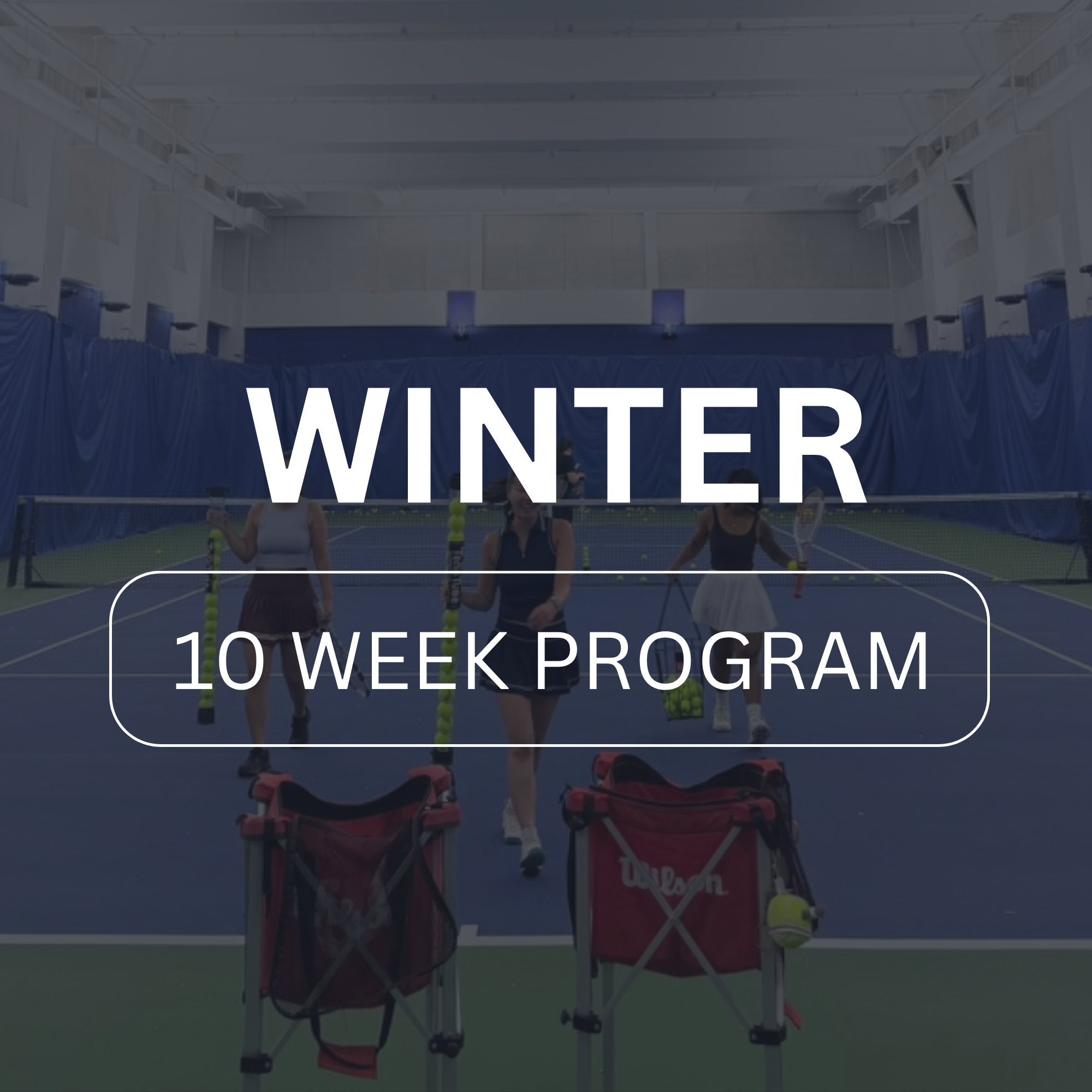 Indoor tennis court with a table set up for a 10-week winter program, featuring tennis balls, bags, and people preparing for training.