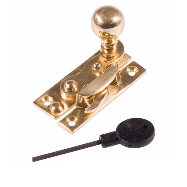 A brass latch with a round knob, a latch lever, and a black plastic key with a long metal shaft.