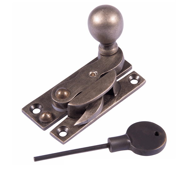 A brass latch with a round knob, a latch lever, and a black plastic key with a long metal shaft.