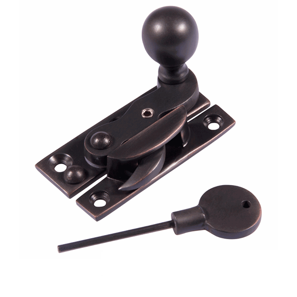 A black mortise lock latch with a keyhole and a separate key with a round handle and a long, thin shaft.