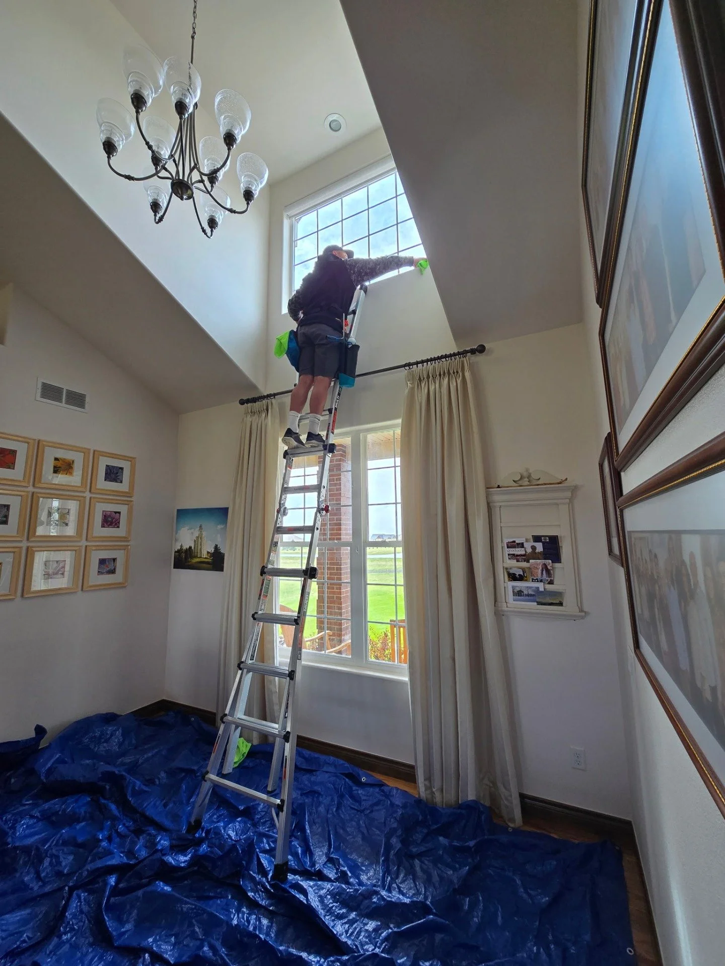 Interior window cleaning technician on ladder in Cheyenne, WY home