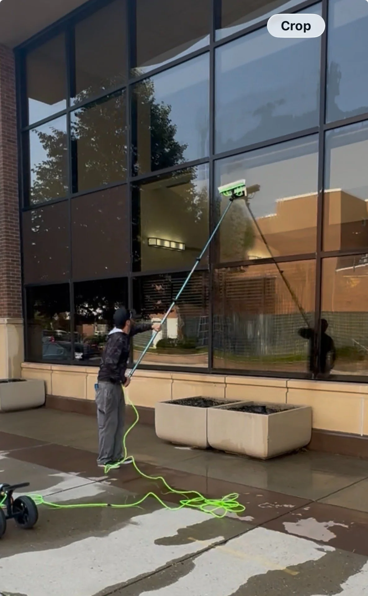 Squeegee window cleaning technique on commercial glass in Cheyenne, WY