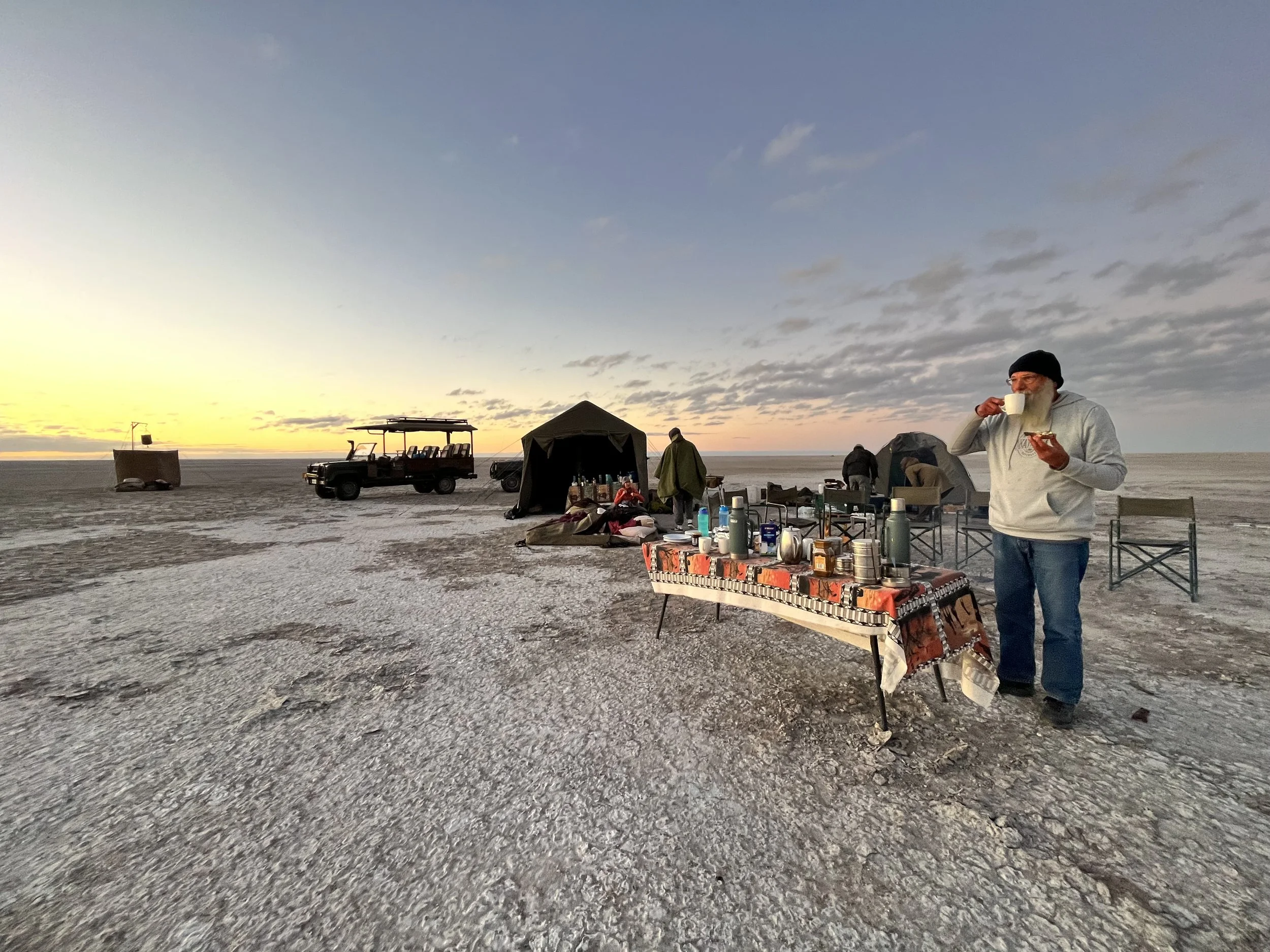A guest drinking an early morning coffee on the wide Makgadikgadi Salt Pans, Botswana.