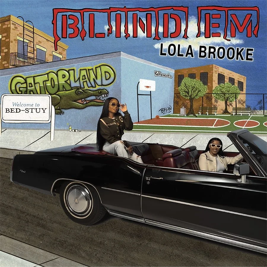 Two women in a black convertible car in front of a colorful mural of an urban scene with graffiti, a basketball court, and trees. One woman is sitting on the edge of the car, and the other is driving, both wearing sunglasses.