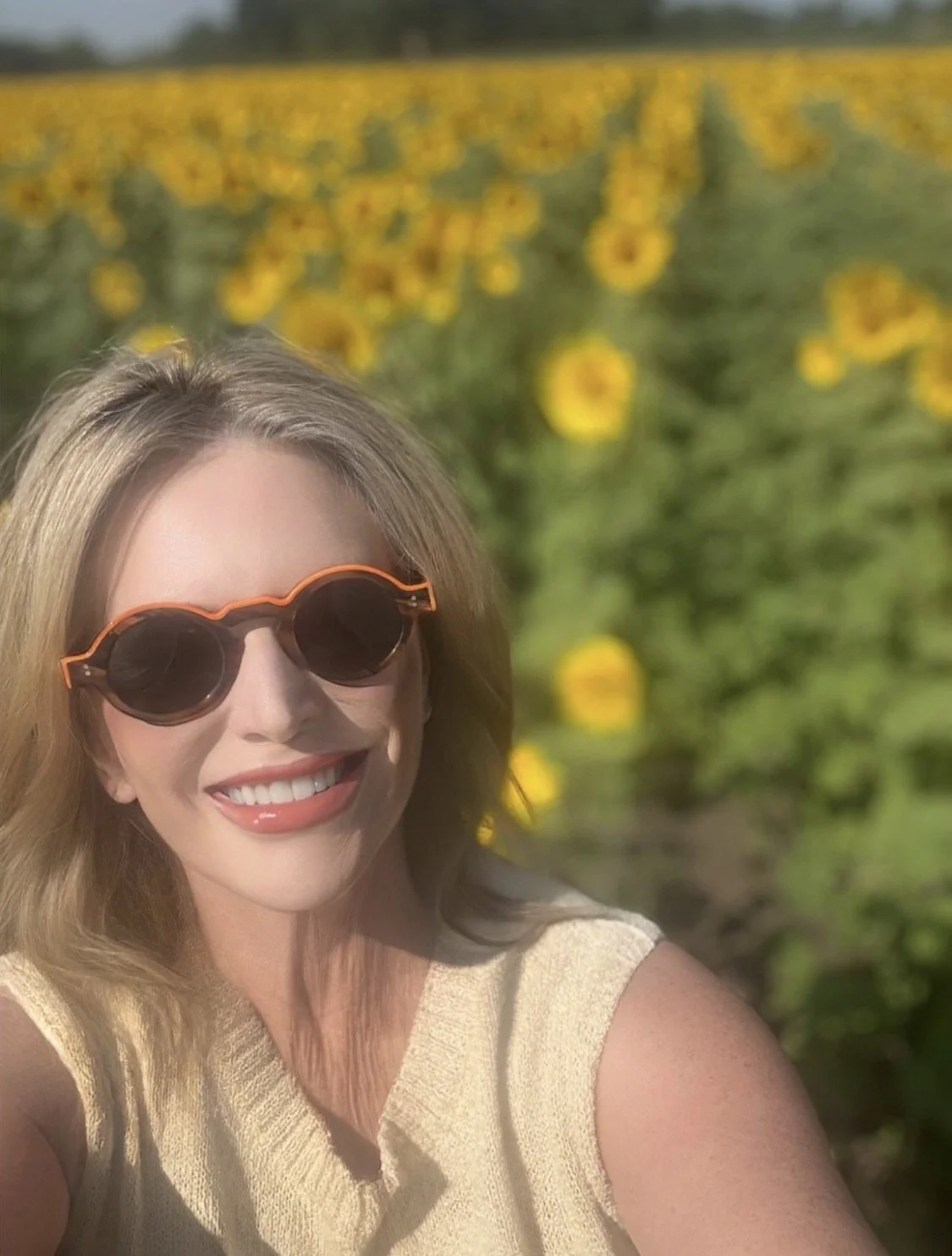 Vicki Ferguson enjoying a sunny day in a Kansas City sunflower field.