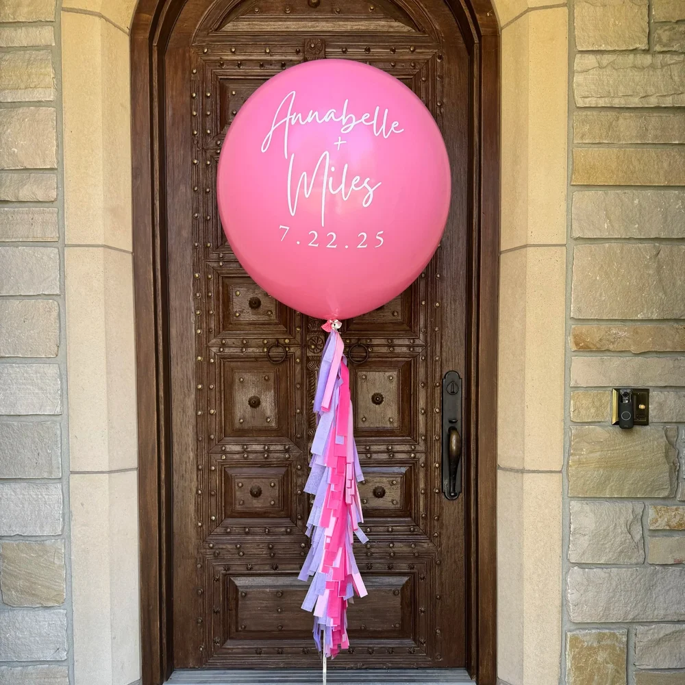 Personalized pink jumbo helium balloon with decorative pink tassels