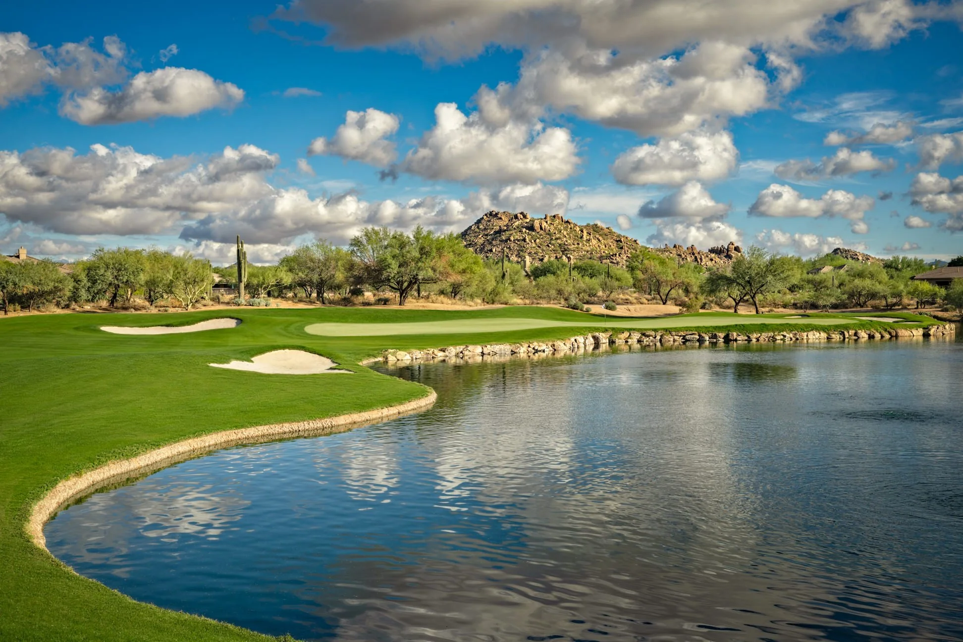Terravita Golf & Country Club in North Scottsdale, Arizona, featuring a desert golf hole with water, bunkers and mountain views.