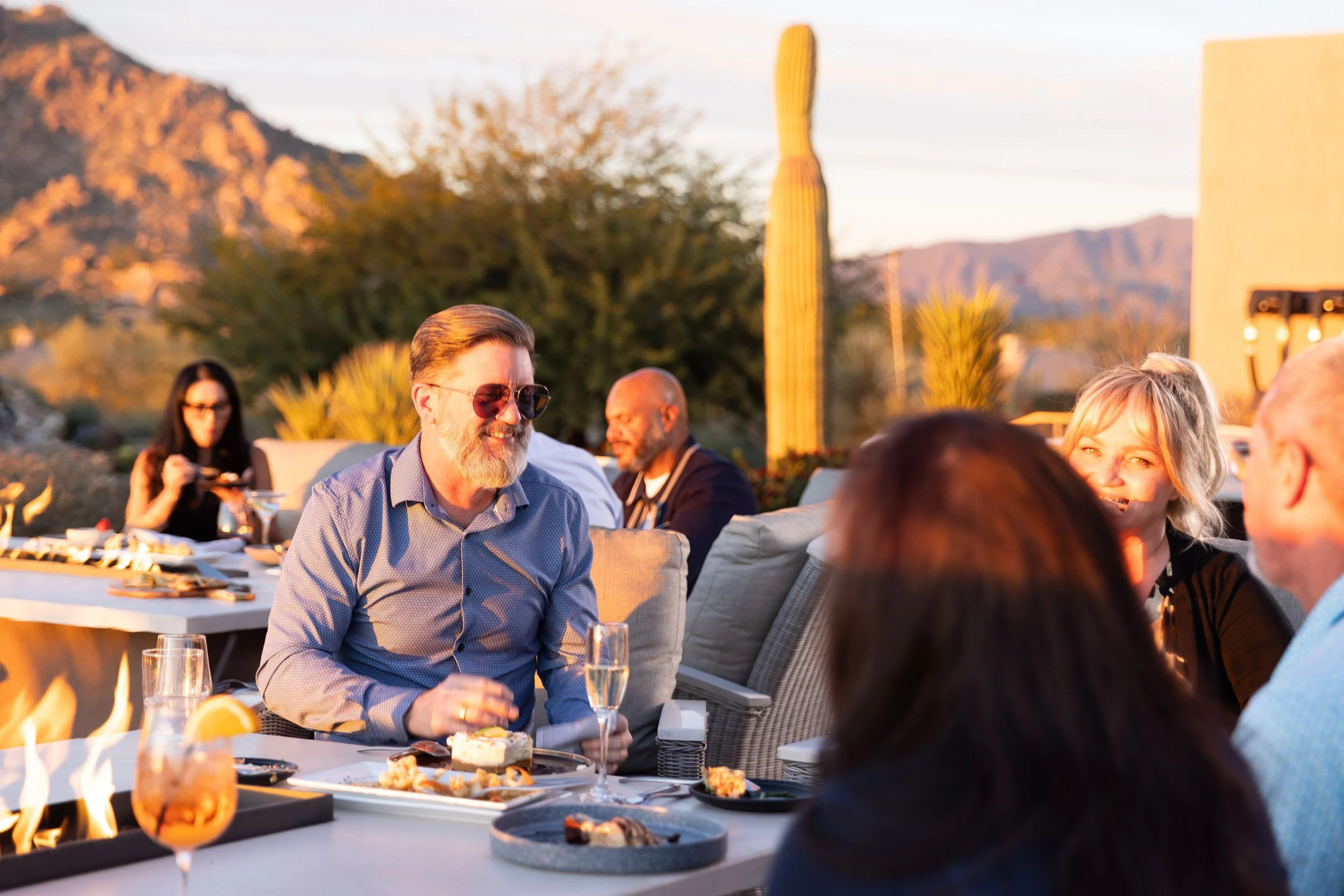 Terravita members enjoying outdoor dining and conversation at sunset in the North Scottsdale desert.