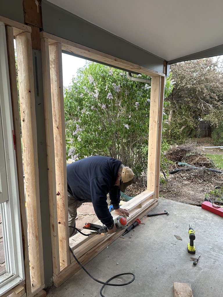 David framing a window on a addition on a residential property.