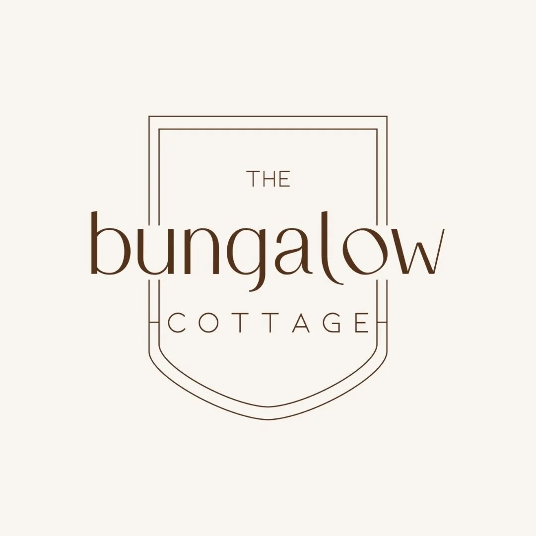 Logo for The Bungalow Cottage with a minimalist design and a shield outline.