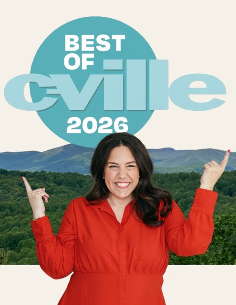 A woman in a red shirt smiling and pointing to a sign that reads "Best of Civile 2026" with a scenic green landscape and mountains in the background.