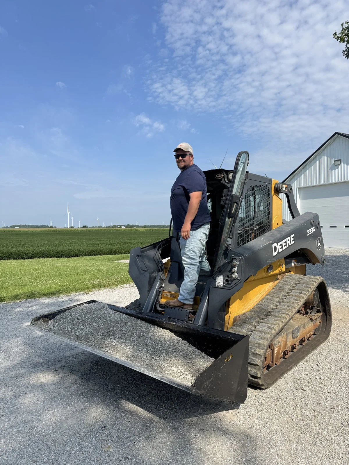 Hayes Volpenhein, owner-operator of Ridgeline Corridor Services, on his John Deere track skid steer in Randolph County, Indiana