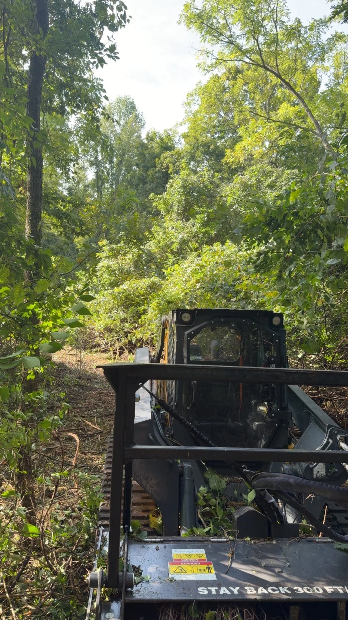 View from a mulcher cab of a freshly cleared path through woods in Richmond, Indiana.