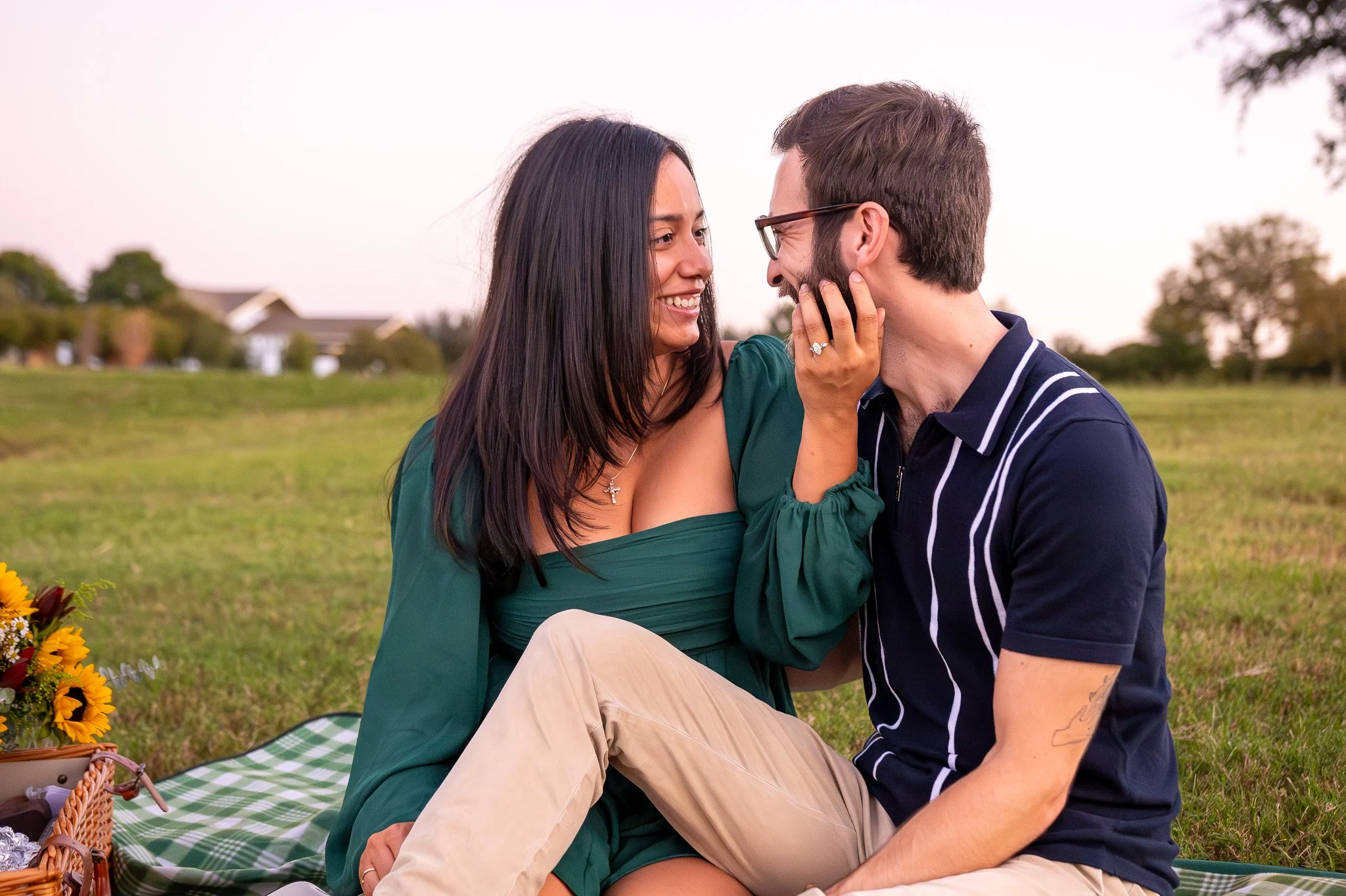 An outdoor picnic style engagement proposal event in a park in Frisco, Texas.