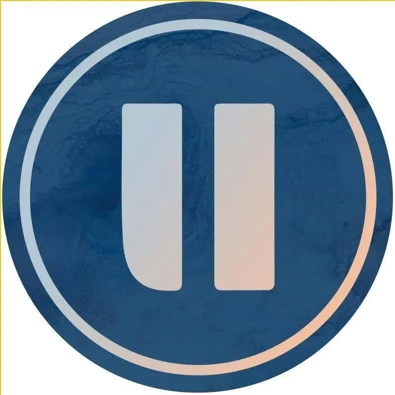 Blue circular button with white pause symbol (two vertical bars).