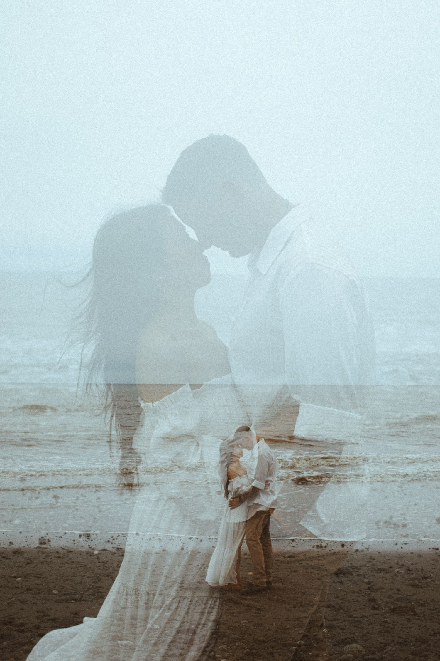 A couple kissing on the beach with a double exposure effect, blending their silhouette with the sea and sky.