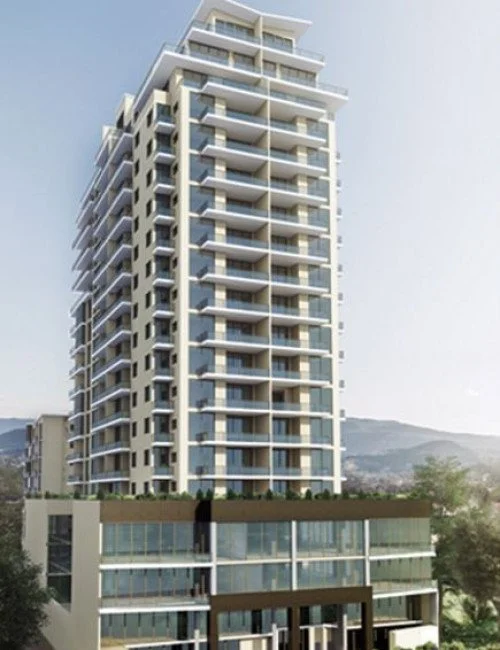 Modern high-rise residential building with multiple balconies and glass windows.