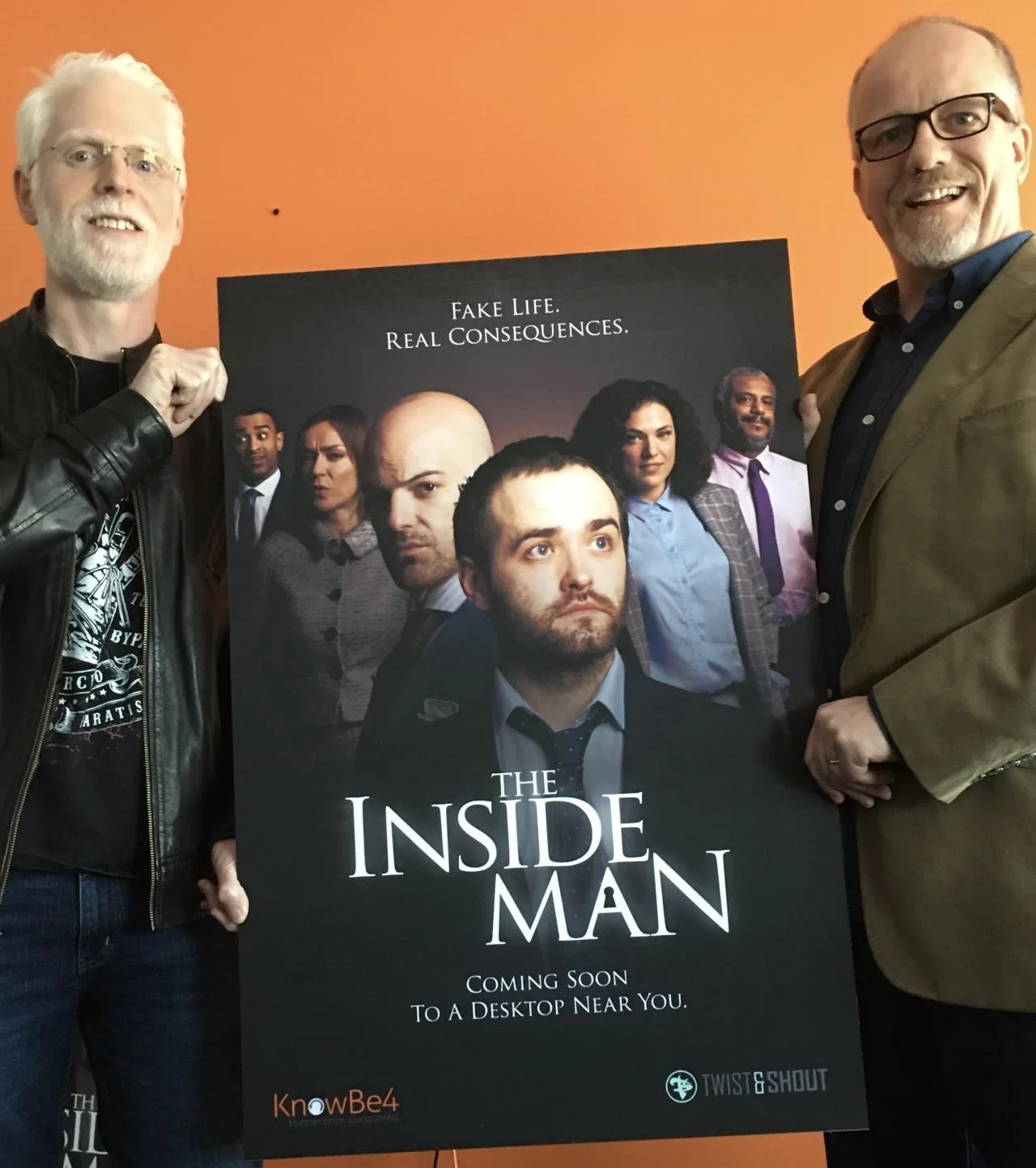 Perry Carpenter and Jim Shields hold the poster for Season 1 of "The Inside Man."